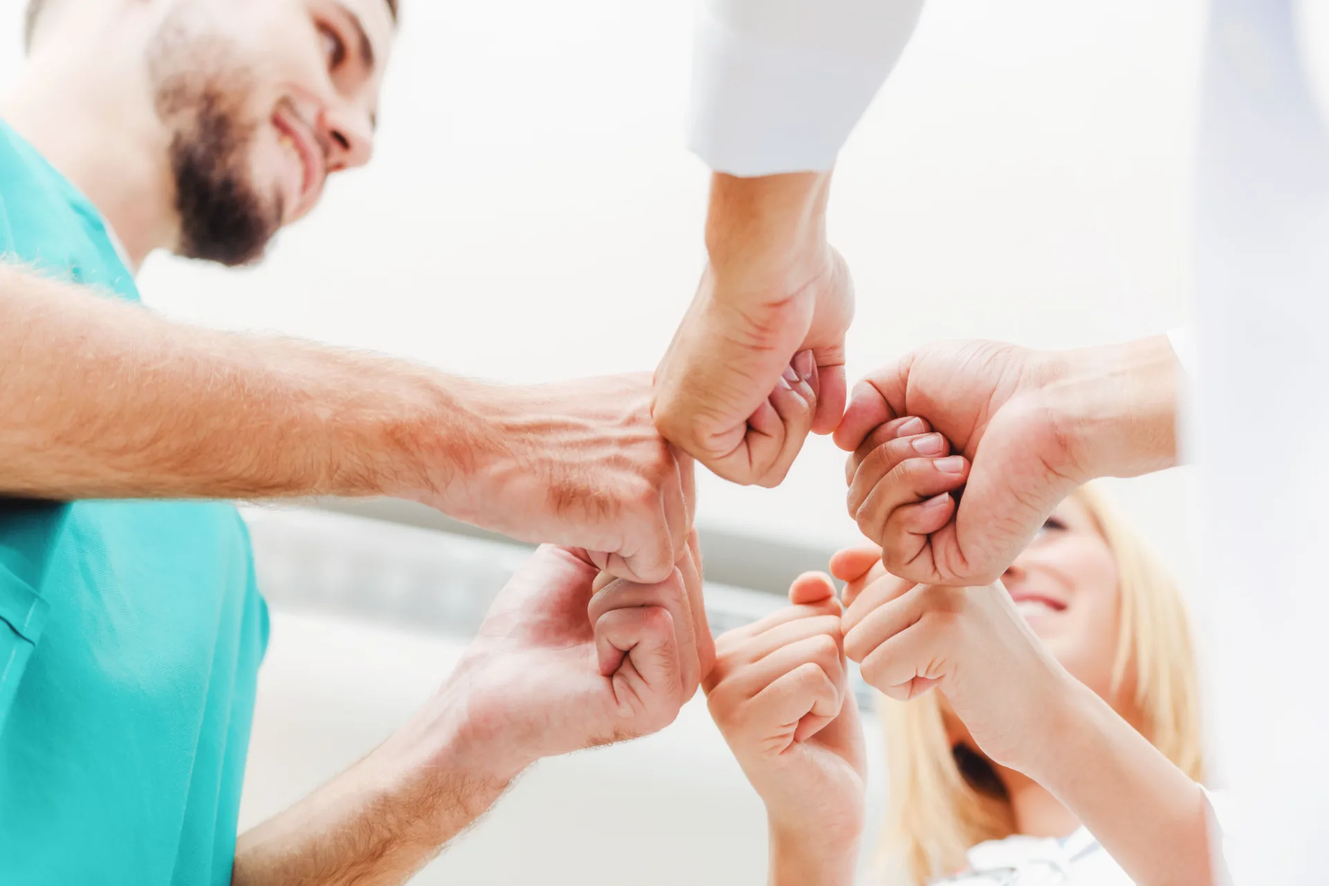 Disability support worker team joining hands together