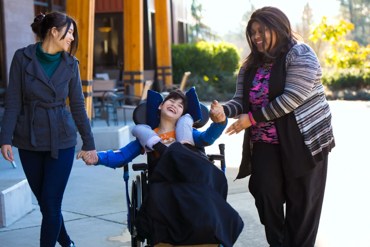 Support workers assisting a young participant to access the community